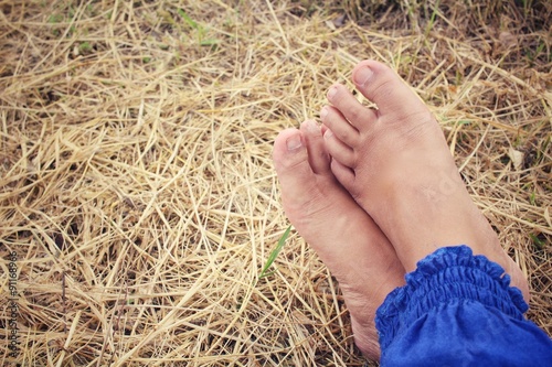Selfie of feet on dried grass