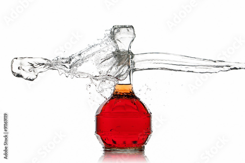 Wine. Bottle of red wine with water splash on white background