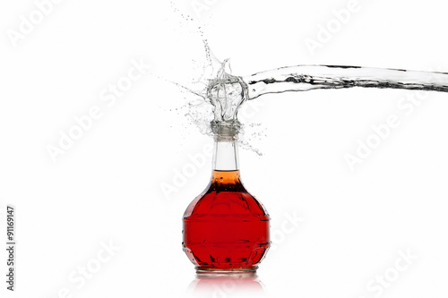Wine. Bottle of red wine with water splash on white background