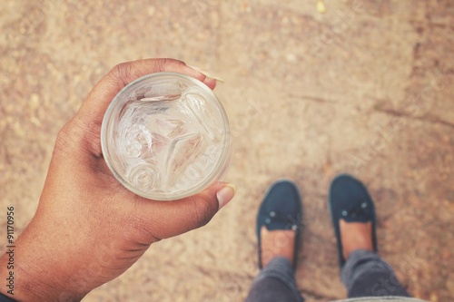 Selfie of drink water on hand with shoes