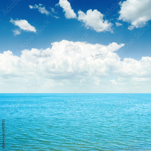 blue sea and white clouds in sky