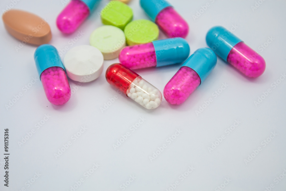 Colored pills, tablets and capsules on white background Colored pills, tablets and capsules on white background
