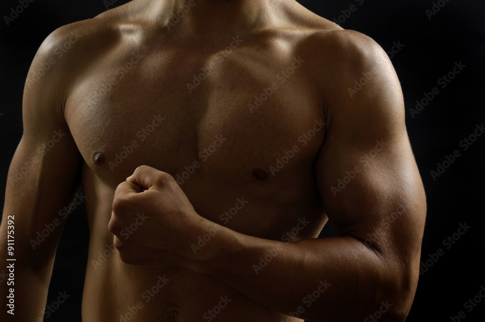 portrai of a man with biceps with black background portrai of a man with biceps with black background