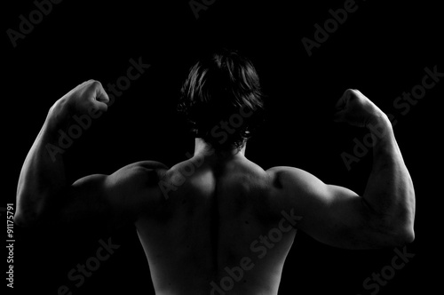silhouette of a man doing strength sword black background