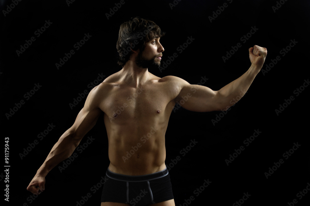 portrait of a man with biceps with black background
