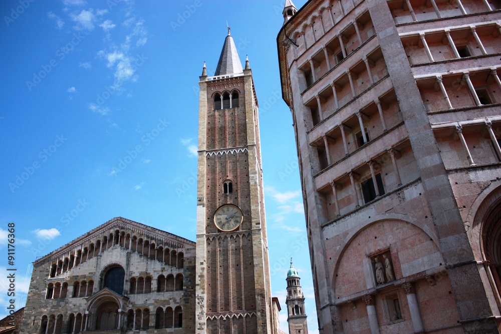 Cathedral of Santa Maria Assunta, the bell tower and the baptistery under blue sky in Parma Italy 