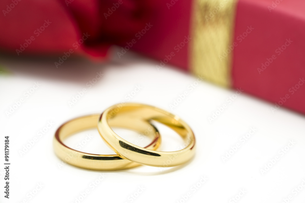 Wedding rings and artificial rose on white background Wedding rings and artificial rose on white background