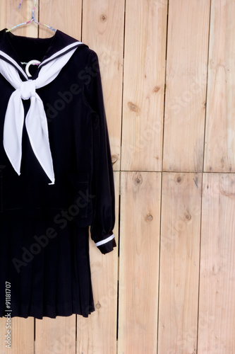 School clothes for girl on wood background