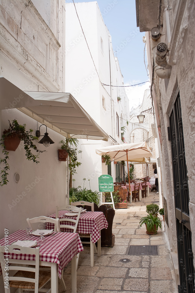 Table set in the alley of Cisternino (Apulia)
