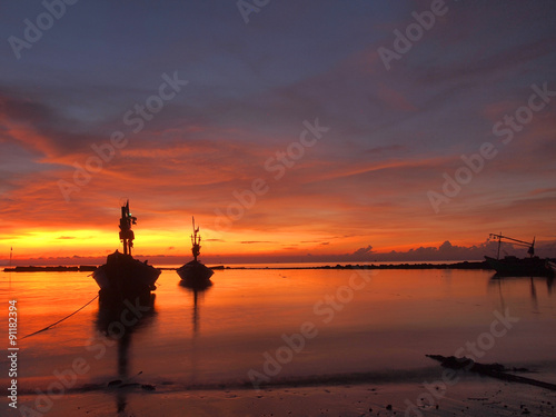 Boat on the beach at sunrise in tide time