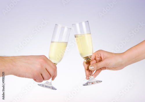 Two people toasting with wine glasses