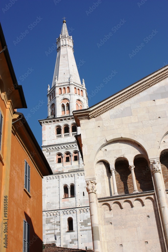 Fototapeta premium Detail of Dom San Geminiano, Torre Ghirlandina Cathedral under blue sky in Modena, Italy