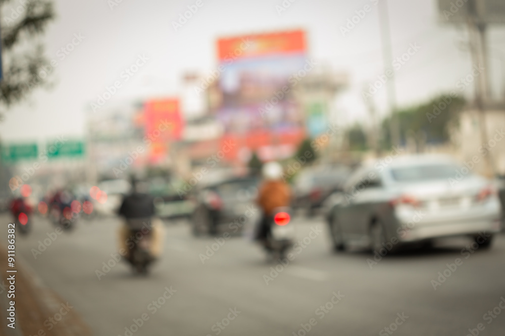 car and motorcycle driving on road with traffic jam in the city