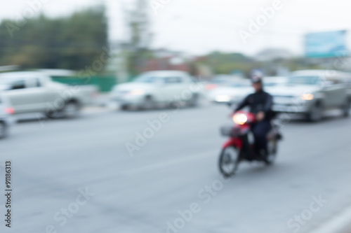 car and motorcycle driving on road with traffic jam in the city © sutichak