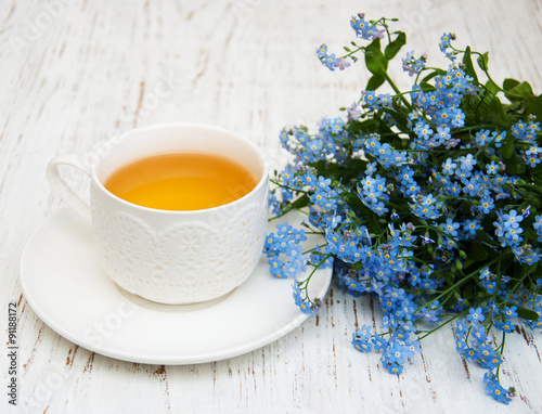 Cup of teand forget me not flowers