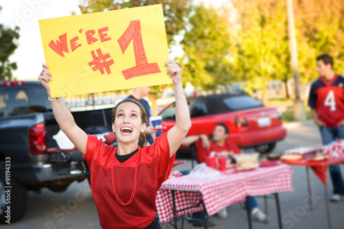 Tailgating: Woman Holds Up Number One Sign For Team photo