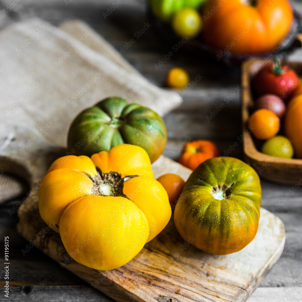 Colorful heirloom tomatoes on rustic wooden background