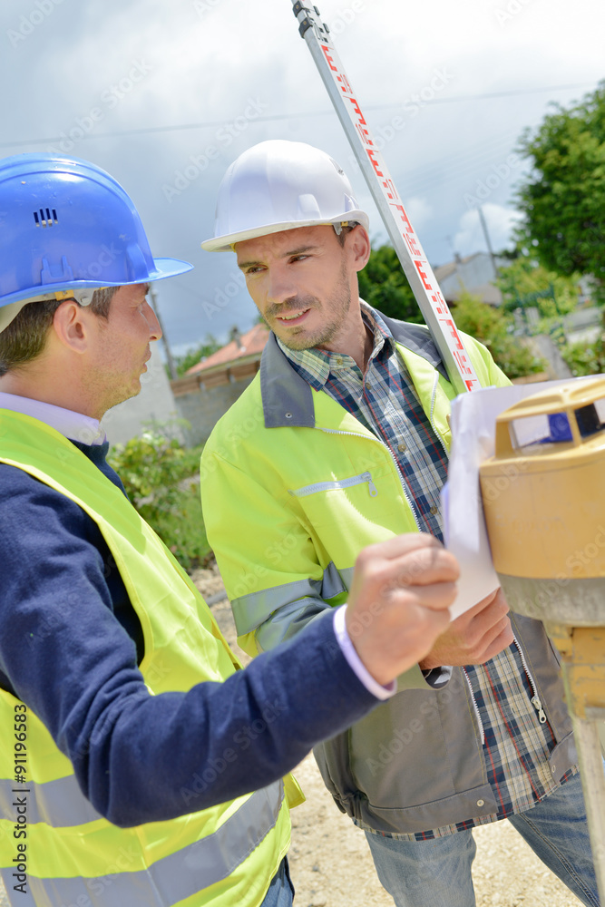 Two site surveyors on a job