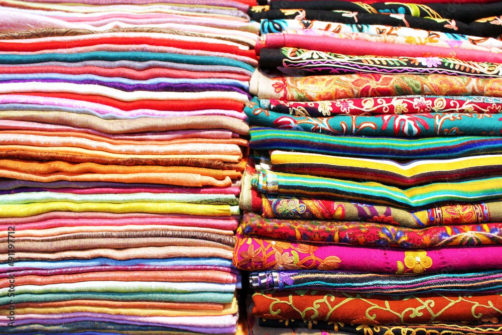 Stacks of colorful scarfs and fabrics background Stacks of colorful scarfs and fabrics background