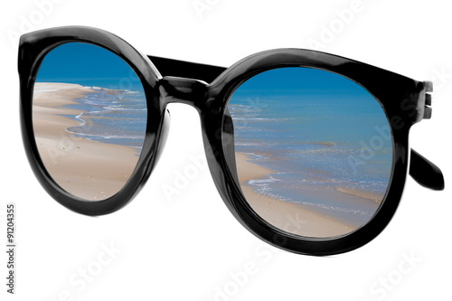 Summertime concept - Sunglasses have a beach with blue sea 