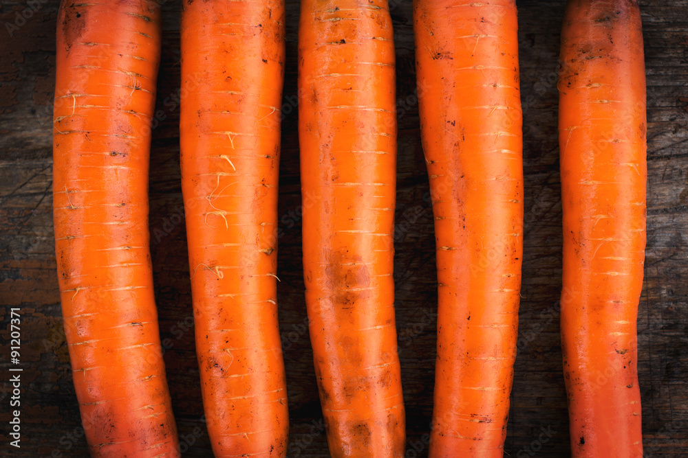 Organic carrots on rustic wooden background Organic carrots on rustic wooden background