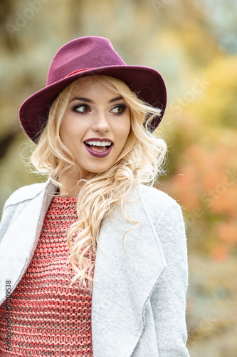 Beautiful elegant woman standing in a park in autumn © ZoomTeam