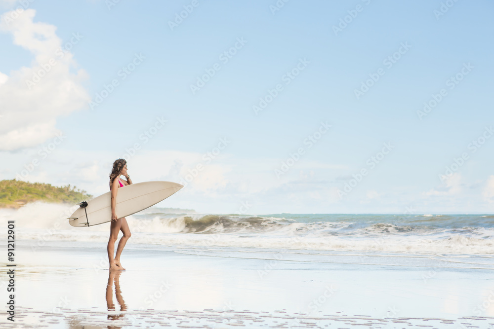 beautiful girl with long hair on the beach with surfboard