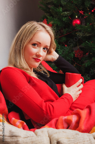 Nice woman sitting in chair with red cup photo