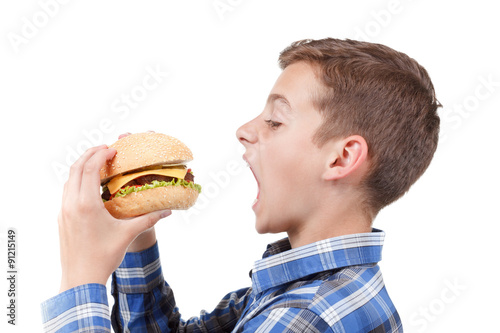Boy eating a burger. isolat...
