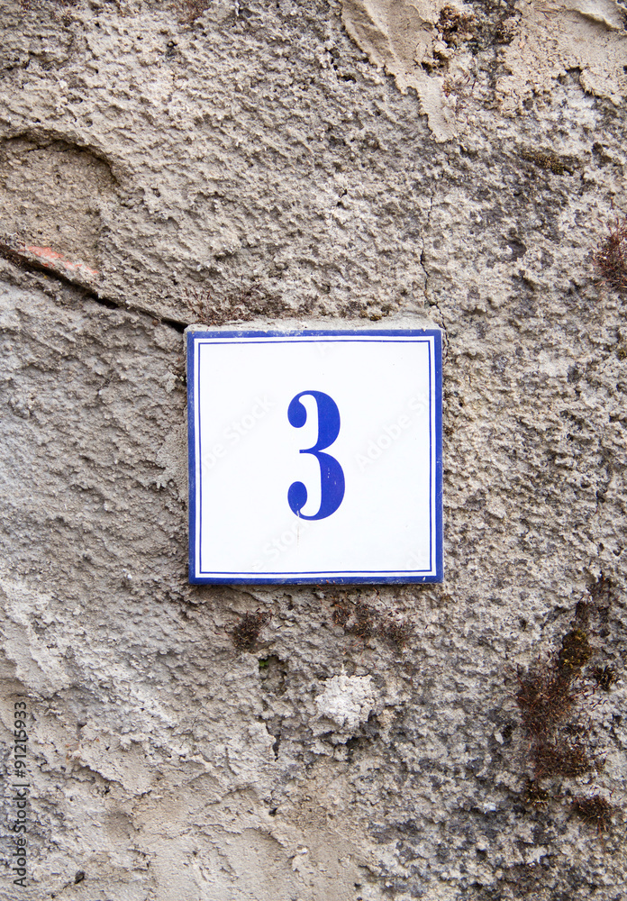 Number three on the grey stone wall Number three on the grey stone wall