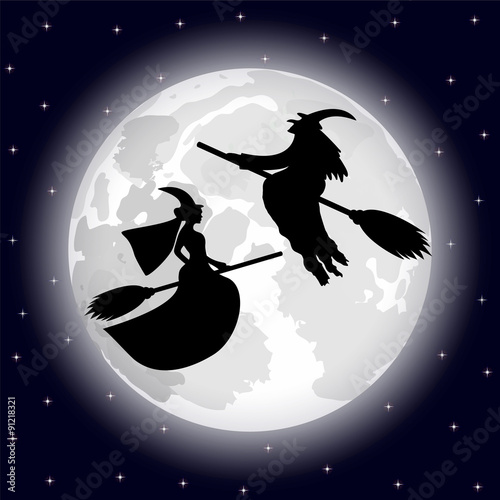 two witches on a background of the full moon on Halloween night