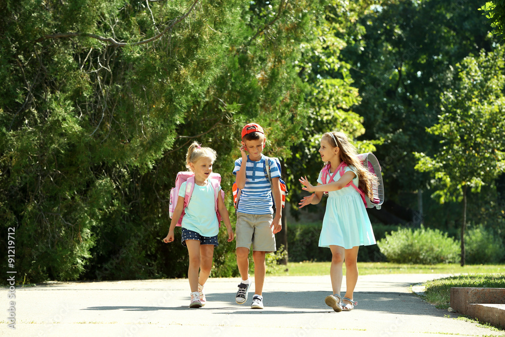 Happy active children with bags outdoors Happy active children with bags outdoors
