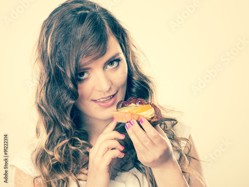 cute woman holds fruit cake in hand