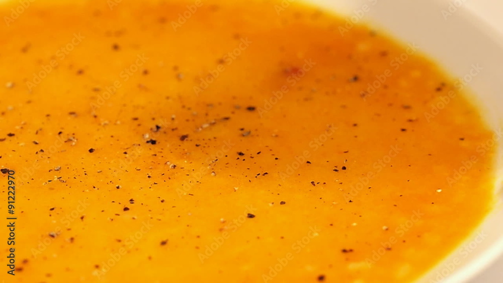 Pouring black pepper over a sweet potato cream soup
Pouring black pepper over a sweet potato cream soup