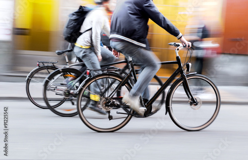 Three men on bikes photo
