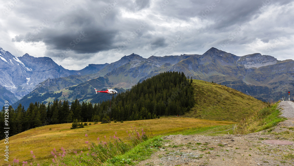 A helicopter flying over the Swiss Alps