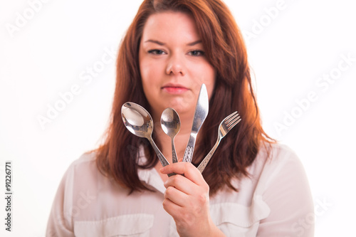 Cook woman holding cutlery set - studio shot