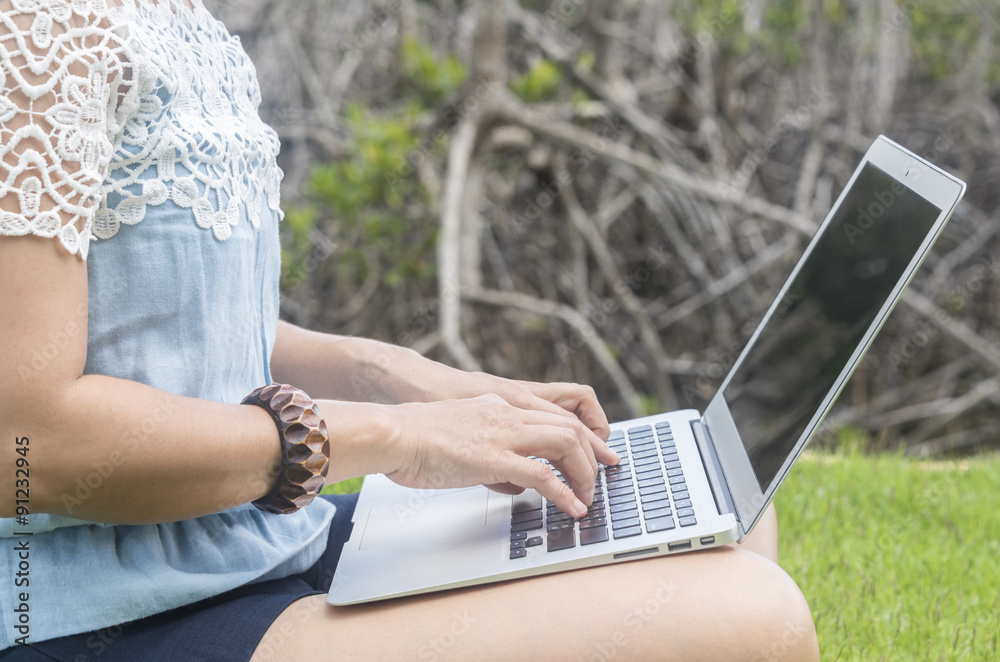 Naklejka premium young women using laptop computer at home.