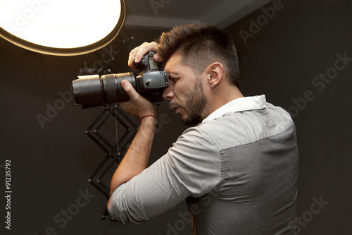 Young man with professional camera