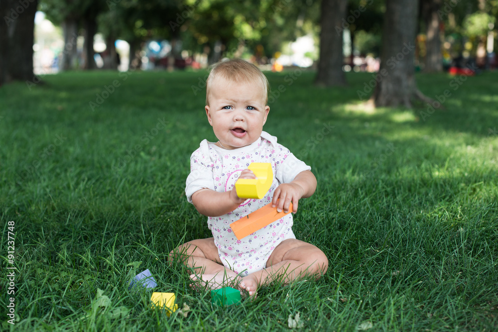 Toddler kid girl playing wooden cubes in green Toddler kid girl playing wooden cubes in green