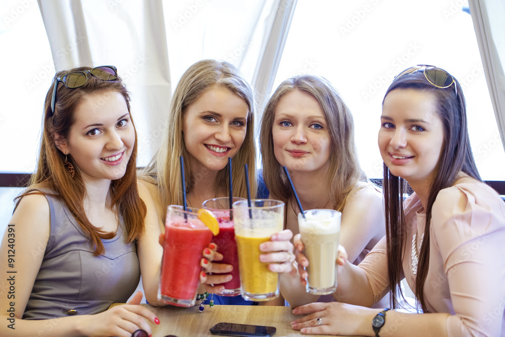 Four young girls have a rest in a summer cafe Four young girls have a rest in a summer cafe
