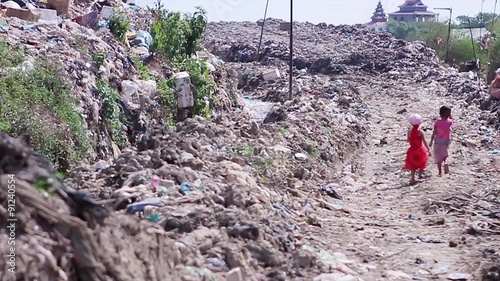 Little children walk on landfills.