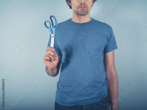 Young man with scissors