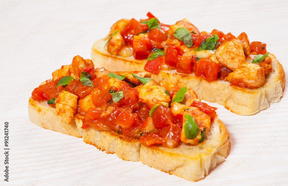 tomato bruschetta with chopped vegetables, herbs, cheese and chicken on ciabatta bread tomato bruschetta with chopped vegetables, herbs, cheese and chicken on ciabatta bread