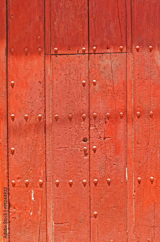 Cherry coloured stained ancient door with studs and planking Cherry coloured stained ancient door with studs and planking