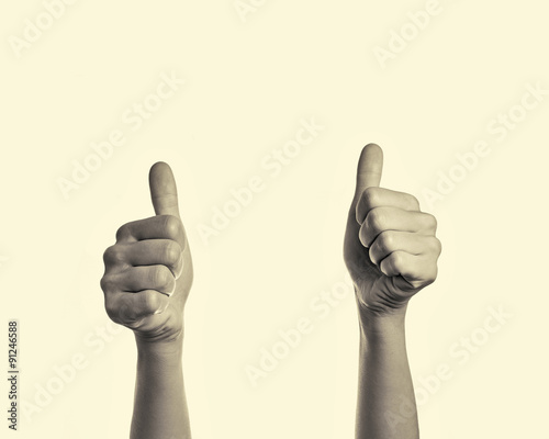 two  hands with a raised thumbs up