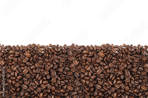 Close-up of roasted coffee beans over white background
