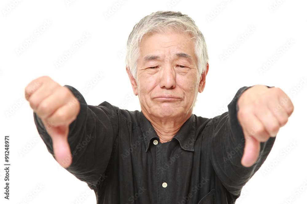 senior Japanese man with thumbs down gesture senior Japanese man with thumbs down gesture