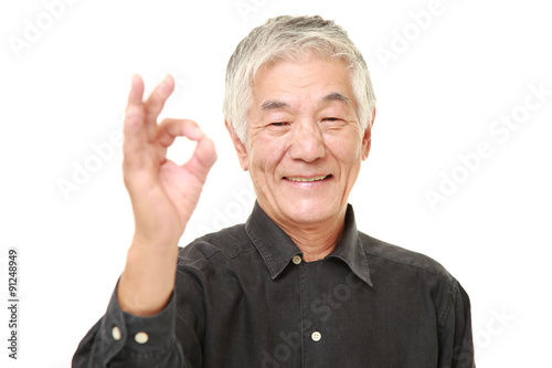 senior Japanese man showing perfect sign