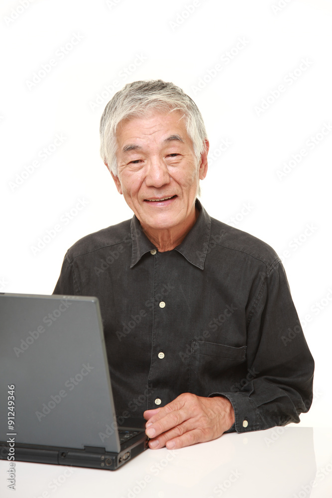 senior Japanese man using laptop computer senior Japanese man using laptop computer